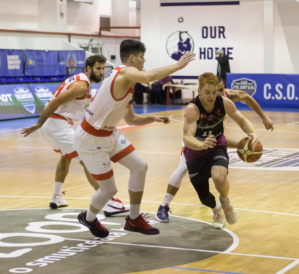 Constanta player drives the ball against Oradea defense in a basketball game in Voluntari Romania