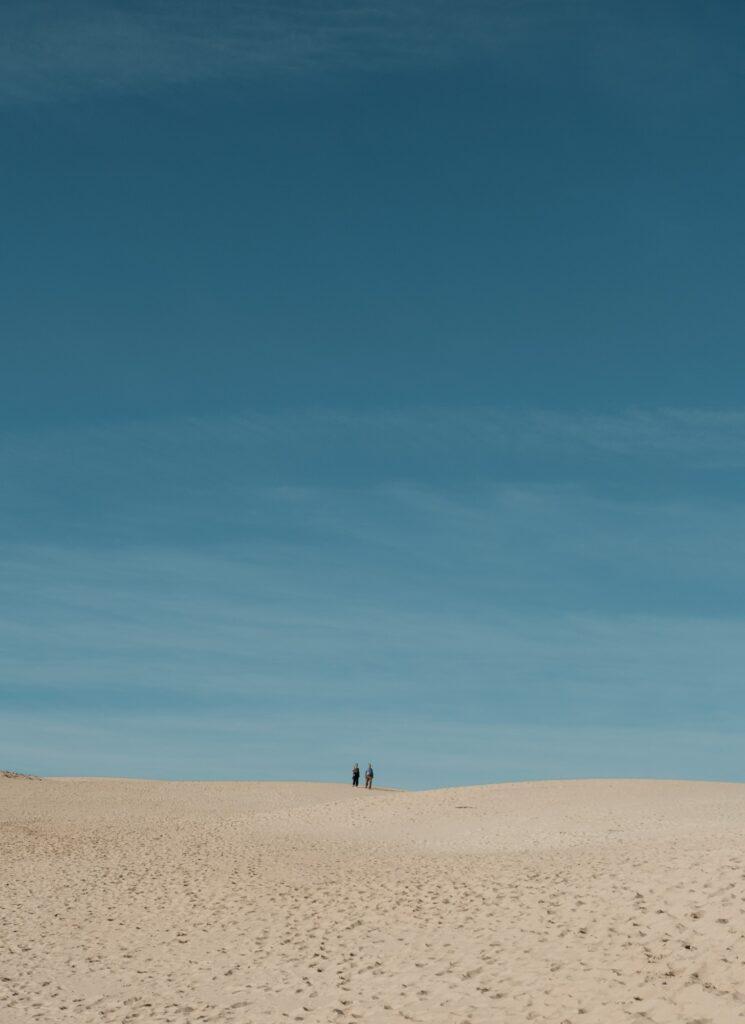 Couple enjoying the sand dunes at Bolonia Andalusia
