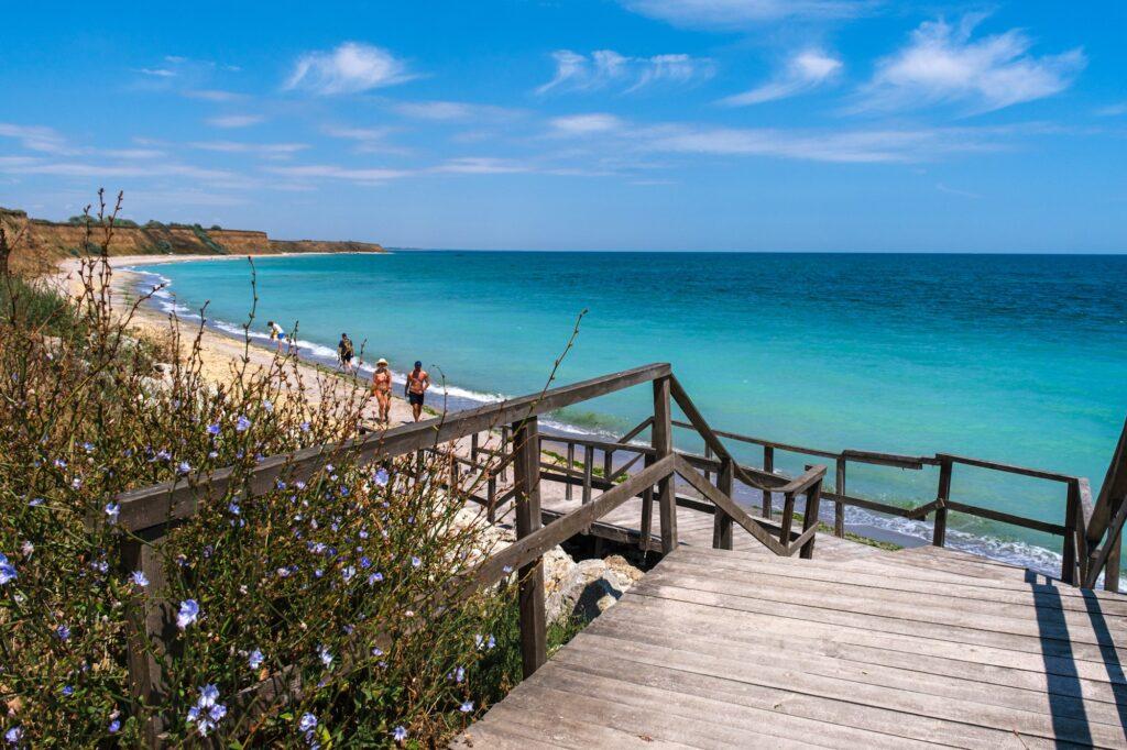 Wooden stairs leading to a turquoise beach on the Bulgarian Black Sea coast 