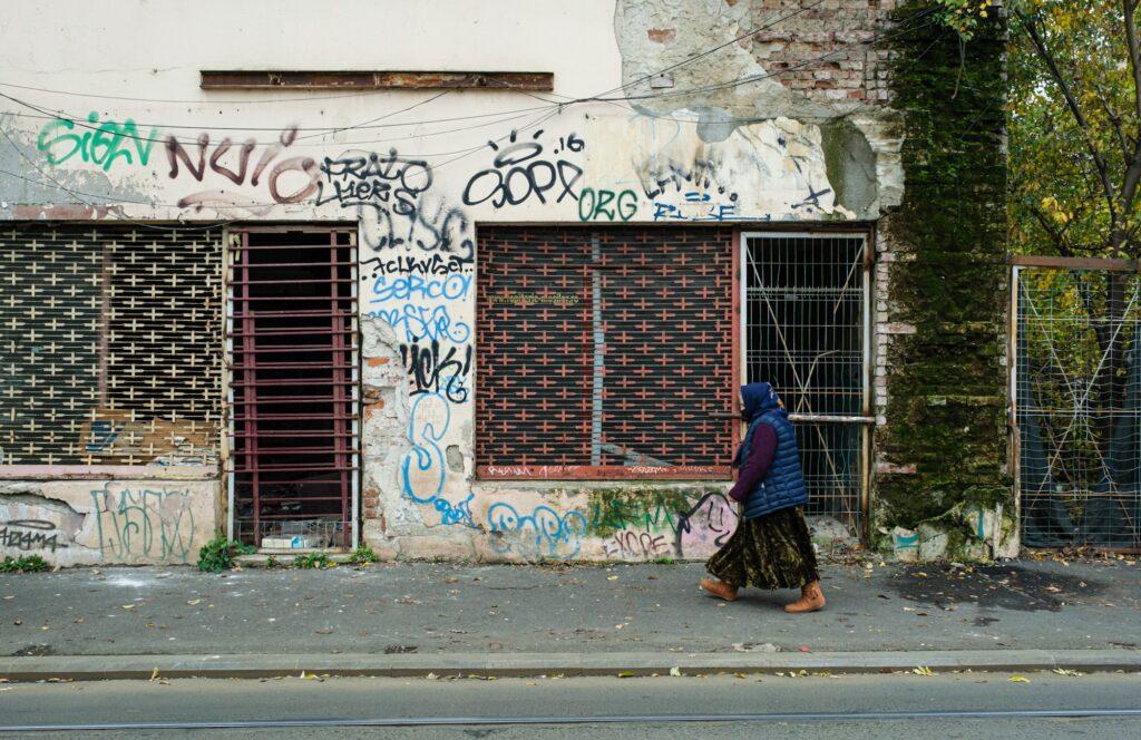 People walking by abandoned stores in Bucharest Romania