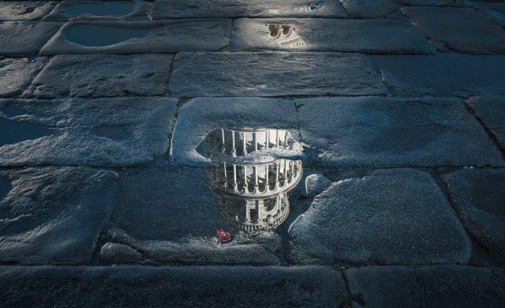 Reflections of the leaning Tower of Pisa in a puddle