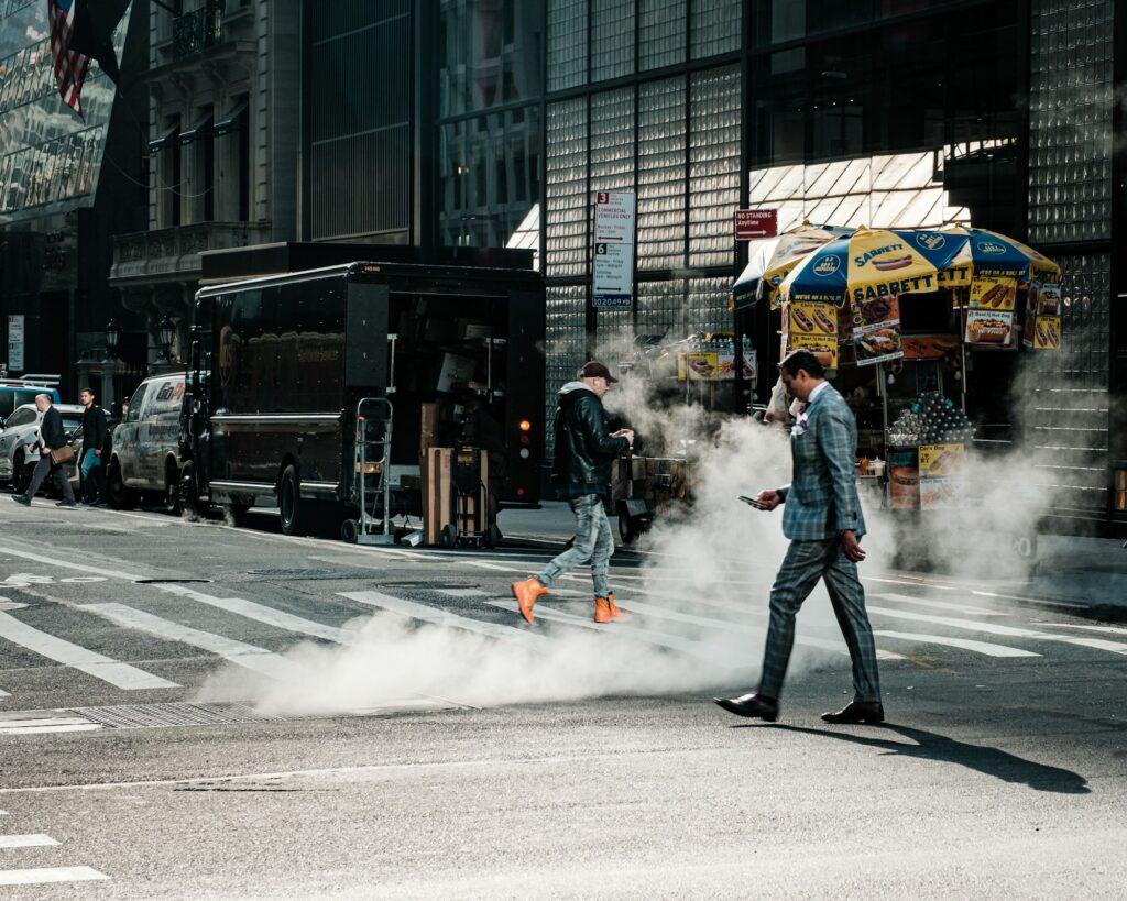 People crossing the street and paying attention to their phones in Manhattan New York