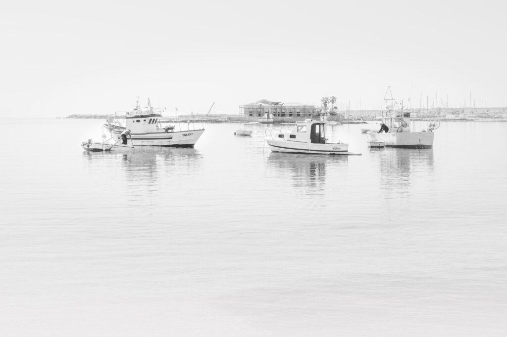 Lazy afternoon with fishermen and fishing boats in Marzamemi SIcily