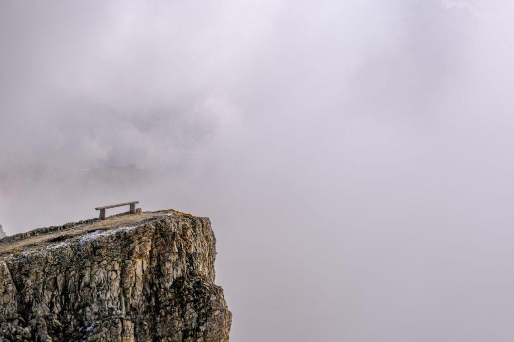 A lone bench shot from Rifugio Lagazuoi and fog everywhere in the Dolomites