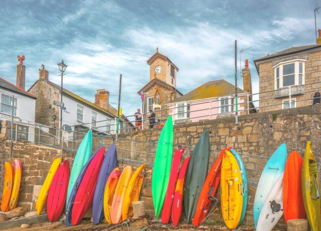 Kayaks lined up in Mousehole harbor Cornwall England