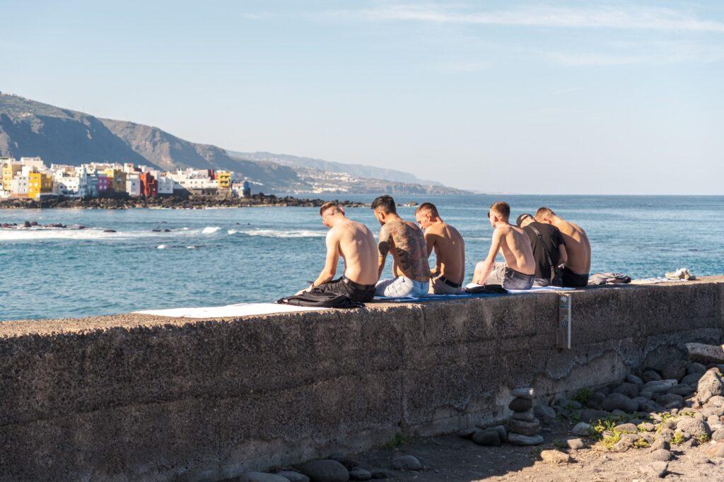 People sitting by the sea in Puerto de la Cruz Tenerife 