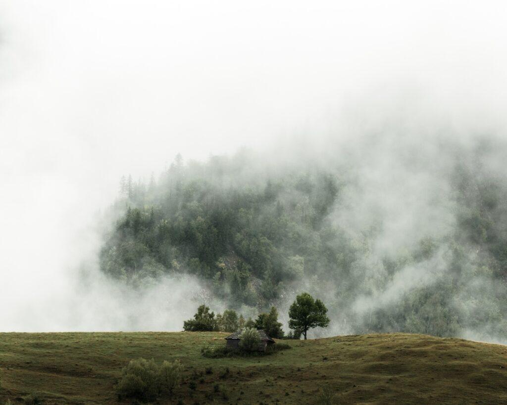 Lonely house on a hill on the road to Pestera village in the Piatra Craiului Mountains