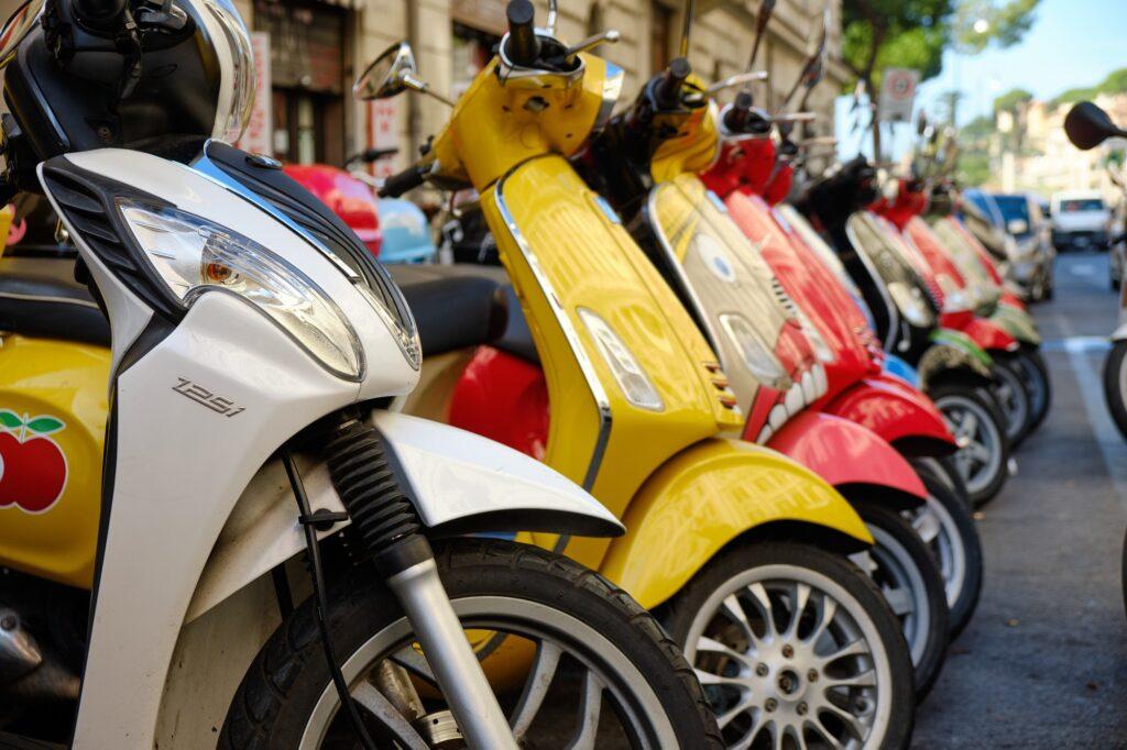 Colorful scooters parked on a street in Rome