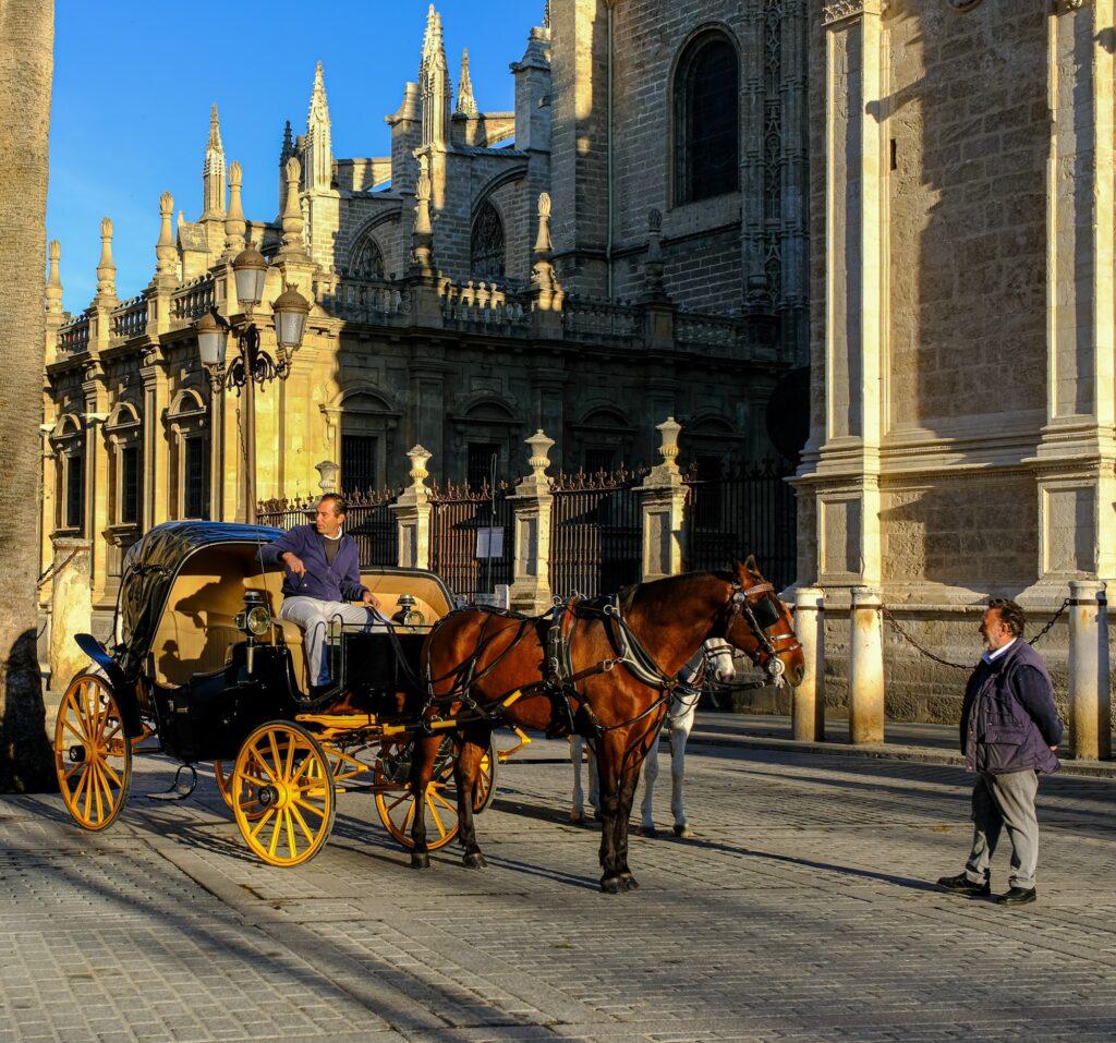 Horse carriage passing near Seville Cathedral in Andalusia Spain