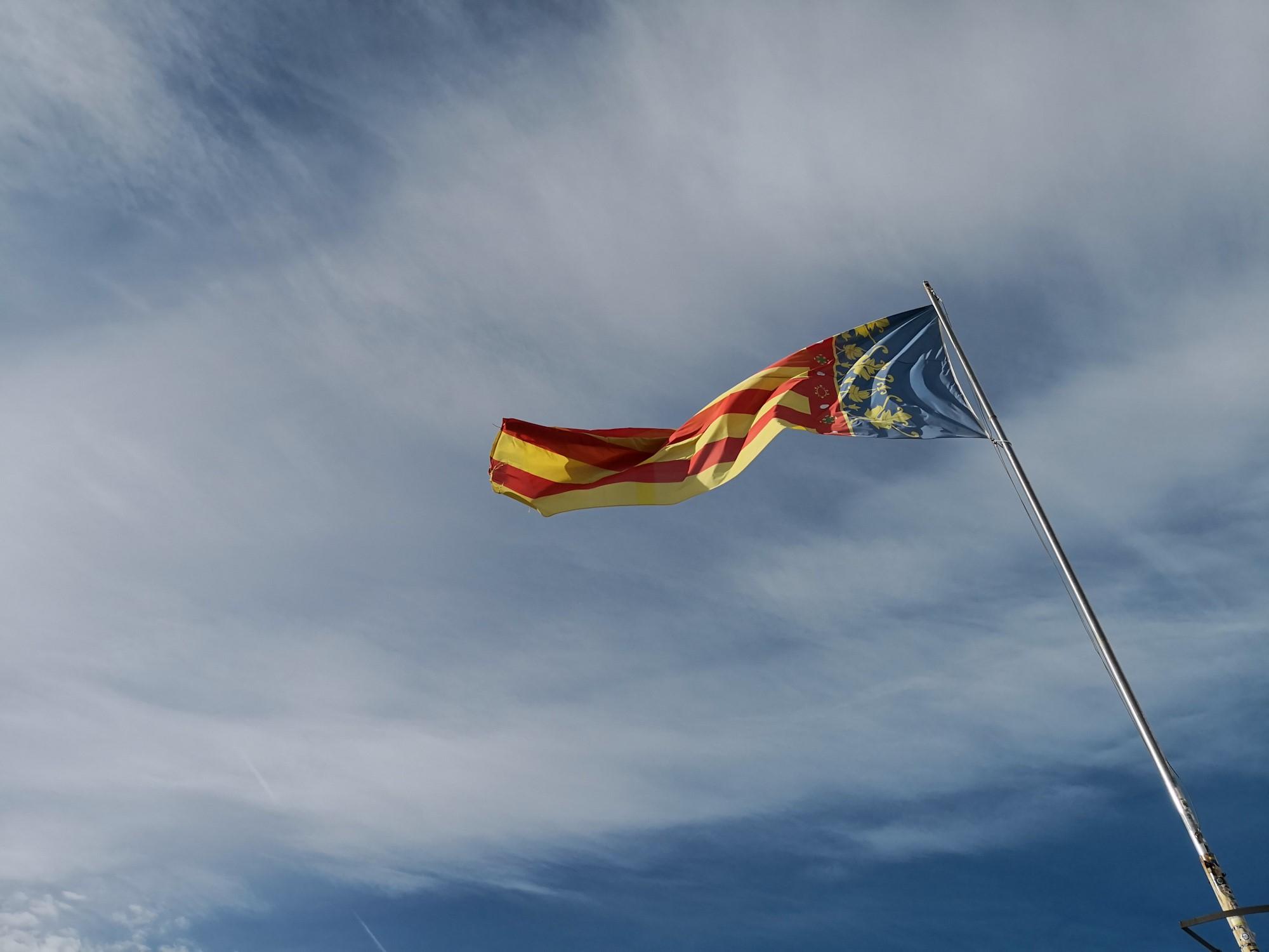 Spanish flag waving in the sky in Valencia Spain