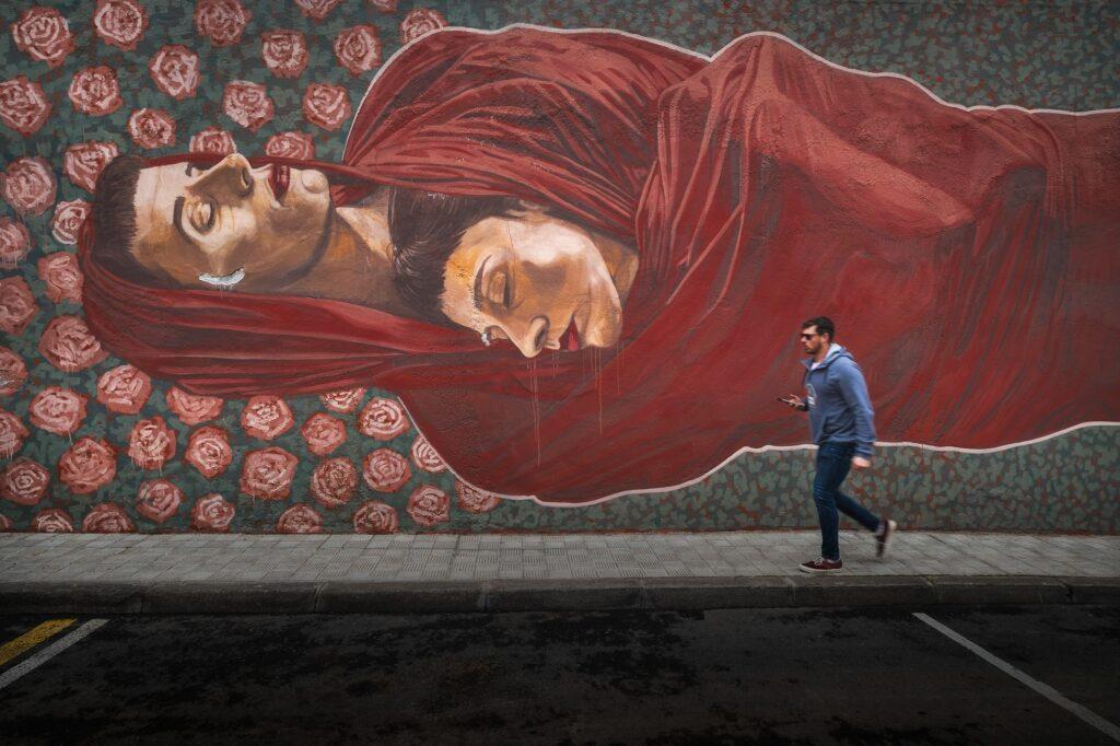 People walking by wall murals in Tenerife Canary Islands