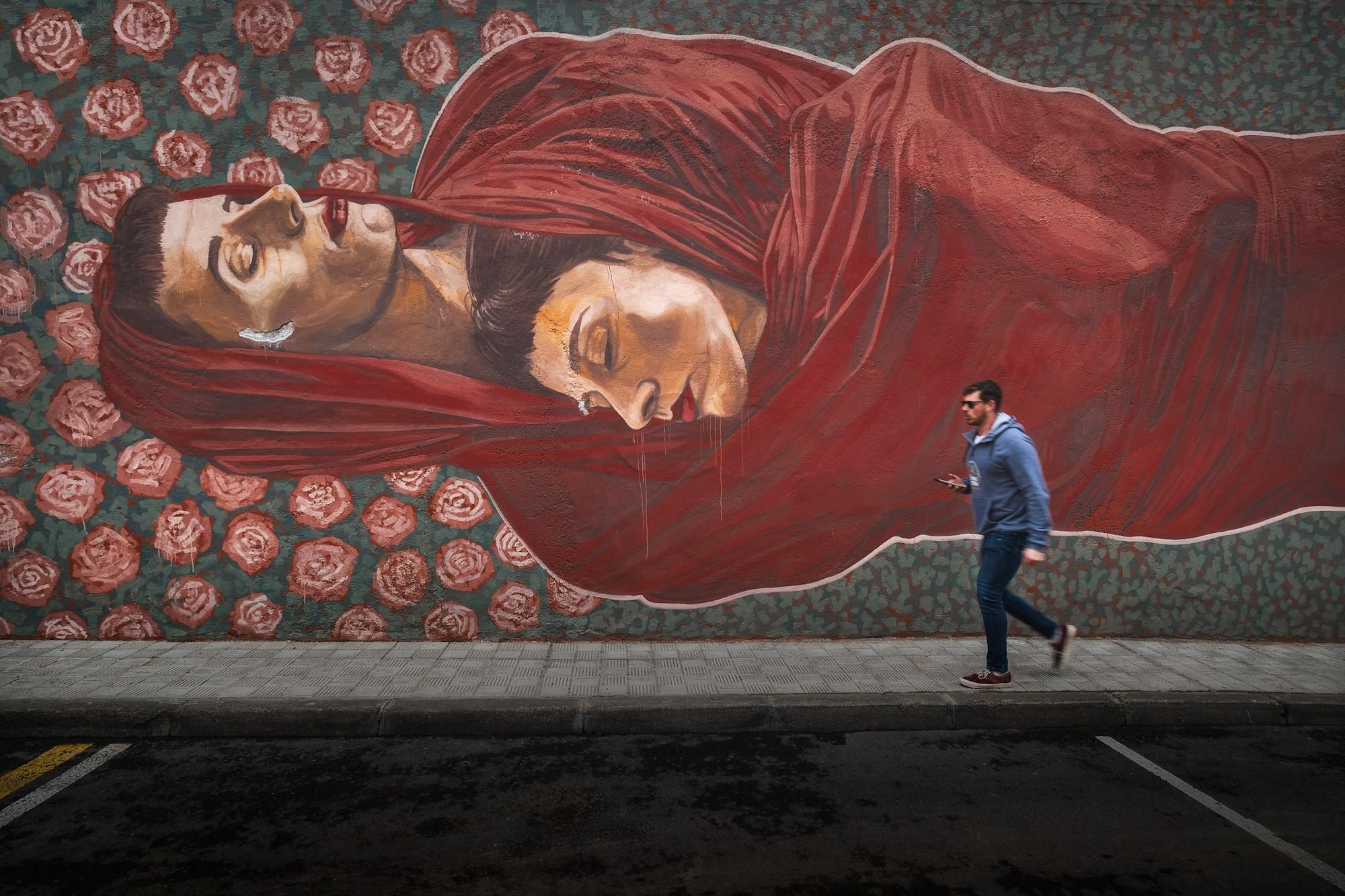 People walking by wall murals in Tenerife Canary Islands