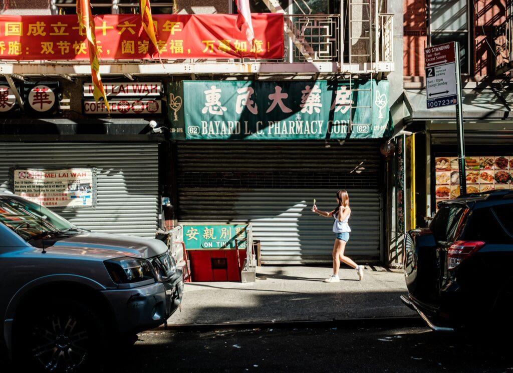 Street scene with girl walking in Chinatown New York
