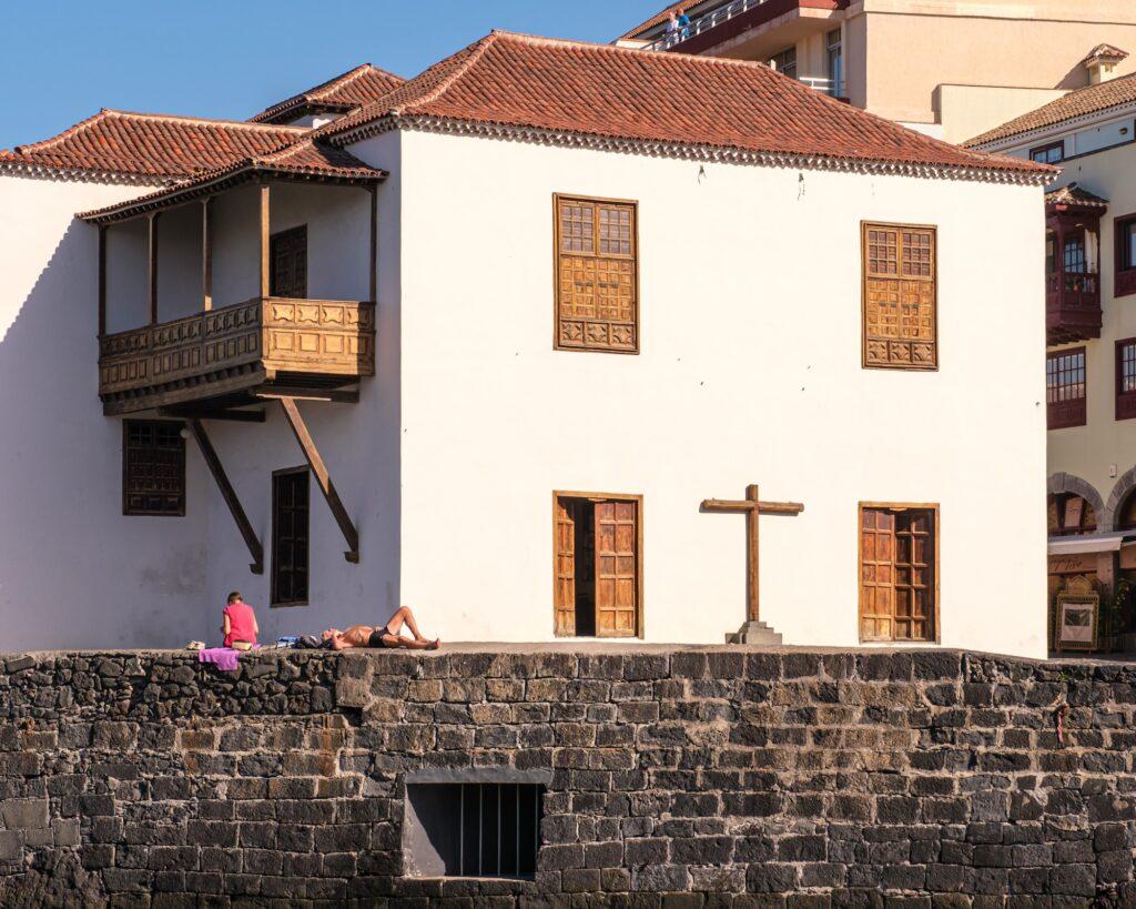 People enjoying the warm weather in Puerto de la Cruz harbor in Tenerife 