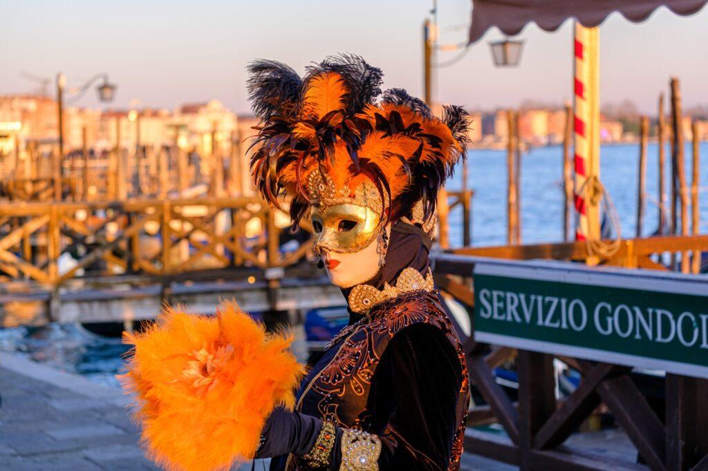 Masked participant at the Carnival in Venice Italy at sunset